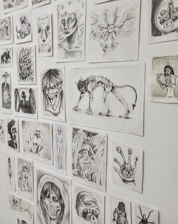 multiple drawings on a wall